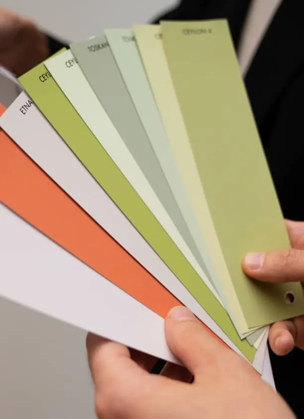 man holding colour palette cards